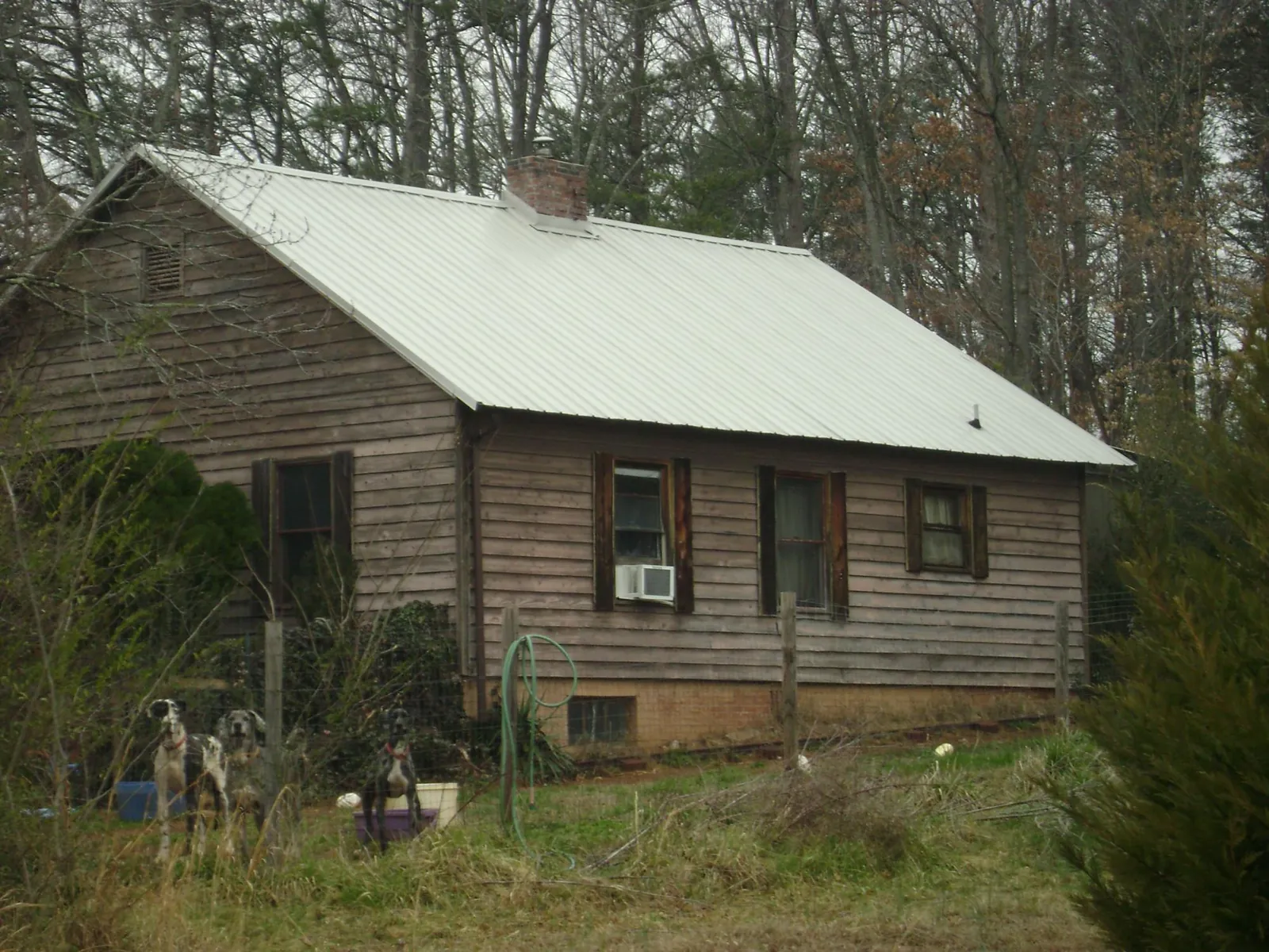 White metal roof on an old wood sided farmhouse, from a Metal Roof Installation job in Millington